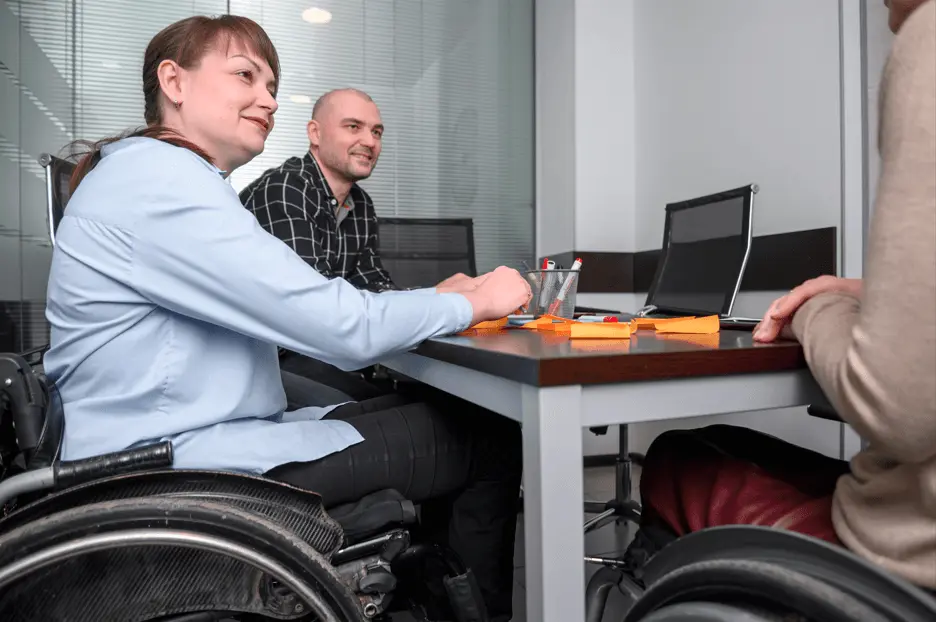 People with different abilities sitting around a table working together